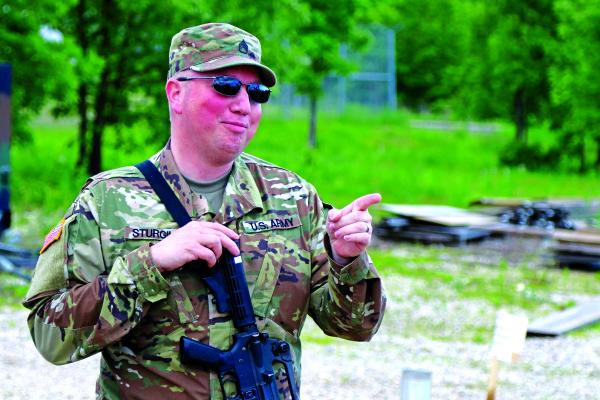 Virgina City-based Staff Sgt. Christopher Sturgill, a sheriff’s deputy with the Madison County Sheriff’s Office wears both Army green and police blue... well, tan and brown actually. (Sumbitted)