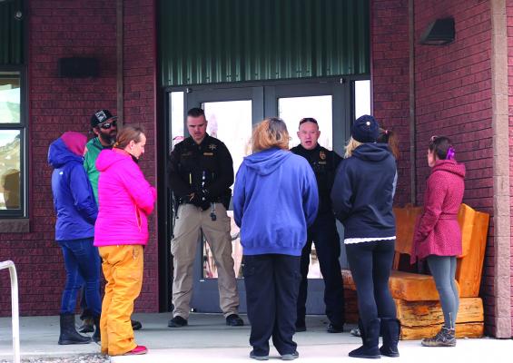 Officer Moore and Madison County Deputy Richardson inform concerned parents of the active investigation regarding a suspicious call Ennis Schools received Jan. 30, and assured parents that students were safe. “We’re in the process of mitigating the threat and are taking this very seriously,” Moore told parents. (C. AVEY PHOTO)