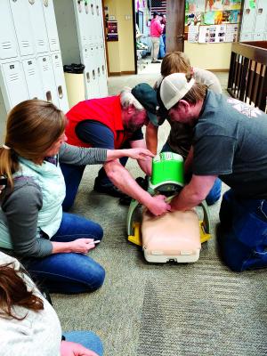 Ennis Ambulance and Madison Valley Rural Fire Department responders practice CPR on a mannequin with a mechanical Lucas device, to provides high quality CPR with constant and consistent profusion.