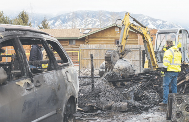 The Madison Valley Rural Fire Department rummages through what is left of a fifth-wheel that caught on fire Jan. 11. PHOTO BY HANNAH KEARSE