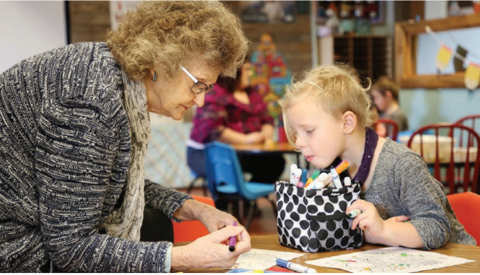 Pearl Hawkins colors with preschooler Kaylee Homen Jan. 10, 2020. Hawkins said she finds coloring relaxing, and enjoys the activity with students because she learns about them while they work together. Photo credit: ANDI BOURNE/SEELEY SWAN PATHFINDER