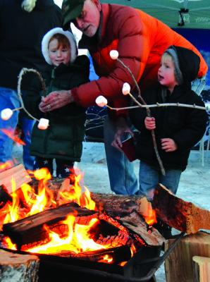 ed by Ennis music director Andrew Scruggs (right) carolers traversed up and down Main Street and even entered businesses like Shedhorn Sports to spread some holiday cheer. A S’mores station — complete with fires for keeping warm and roasting marshmallows — proved to be one of the more popular additions to the Ennis Christmas Stroll on Friday, December 7.