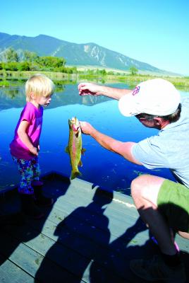 Aaron Davis (right) holds the fish his daughter Anaiah landed with some help from Mom, Christen, at the Ruby Habitat Foundation’s Labor Day Family Fishing outing, held near Laurin on Labor Day, Sept. 3 (J. Taylor)