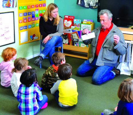 When Ken Shields (right) of the Virginia City Elks Lodge, showed ECCS students the $3,500 Elks check for preschool improvements, they didn’t think it looked like money. (R. Colyer)