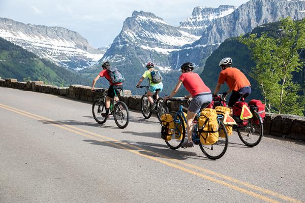 A group of touring cyclists pedals through Glacier National Park. The TransAmerica Trail, a popular touring route, runs coast-to-coast and passes through the Madison and Ruby valleys. (Tom Robertson/Adventure Cycling Association)