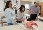 Ennis ambulance manager, Patti Austin, AEMT (l) and Julie Gannon, EMT follow directions from Dr. Paul Menkhaus to aid a patient’s respirations. PHOTO BY HANNAH KEARSE