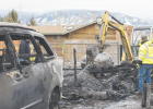 The Madison Valley Rural Fire Department rummages through what is left of a fifth-wheel that caught on fire Jan. 11. PHOTO BY HANNAH KEARSE